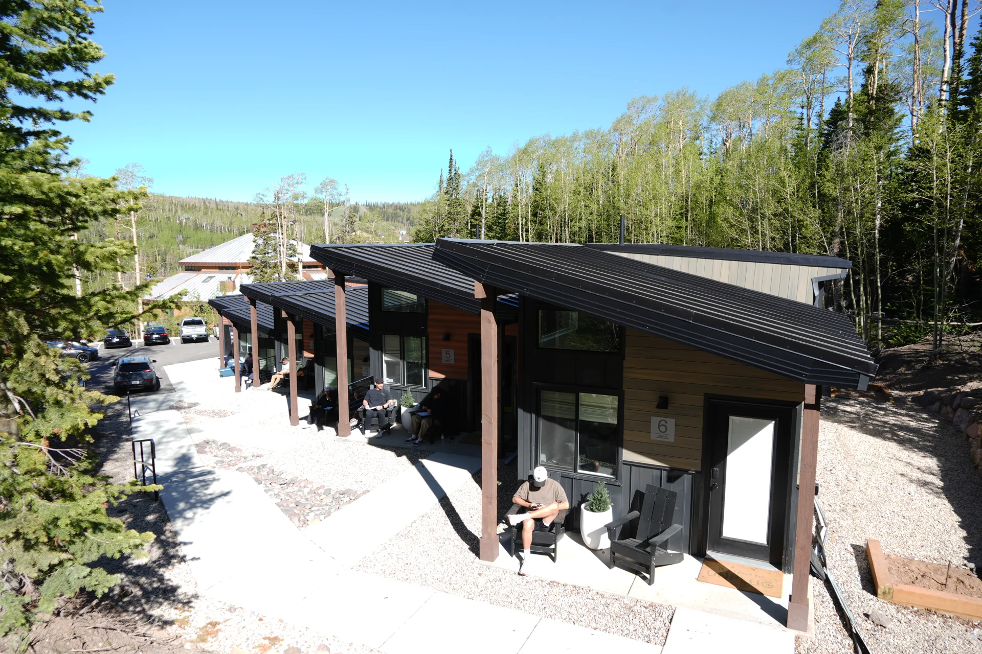 Guests sitting on their separate porches along the Unplug cabin row
